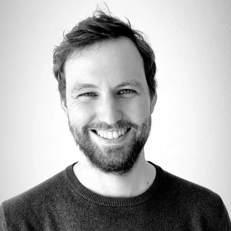 Christian Eichler, smiling, in a black-and-white portrait.